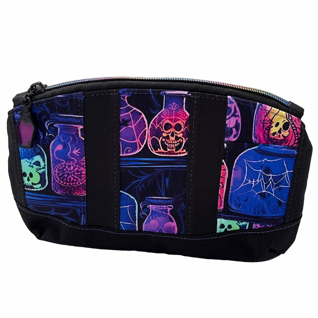 A zippered pouch against a white background. Pouch has stripes of neon potions and black PUL fabric, with a black canvas base. A black zipper with rainbow teeth and a black and purple glitter potion zip pull.