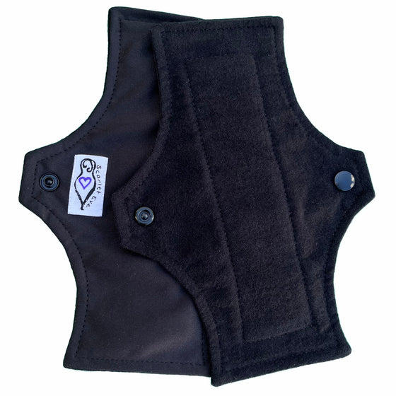 Scarlet Eve Basics Mini Pad. Top: Soft, black cotton flannel. Back: Solid black PUL. 2 layer bamboo fleece booster sewn in. The original lightweight pad from Scarlet Eve.