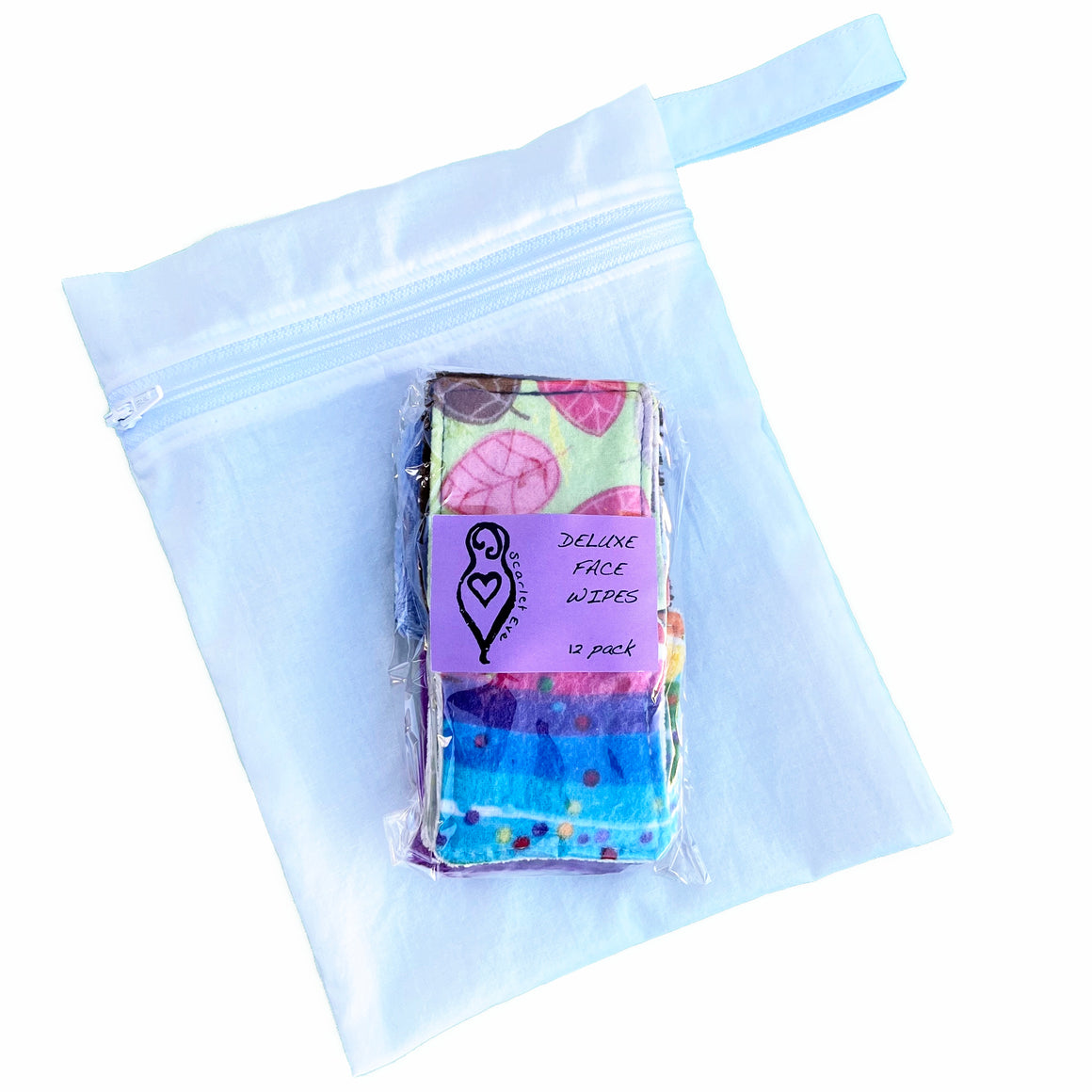 Scarlet Eve Deluxe Face Wipes Wash Bag Set. A pack of 12 Deluxe Face Wipes, packaged in home compostable clear cello bag, sitting on top of a white cotton wash bag.