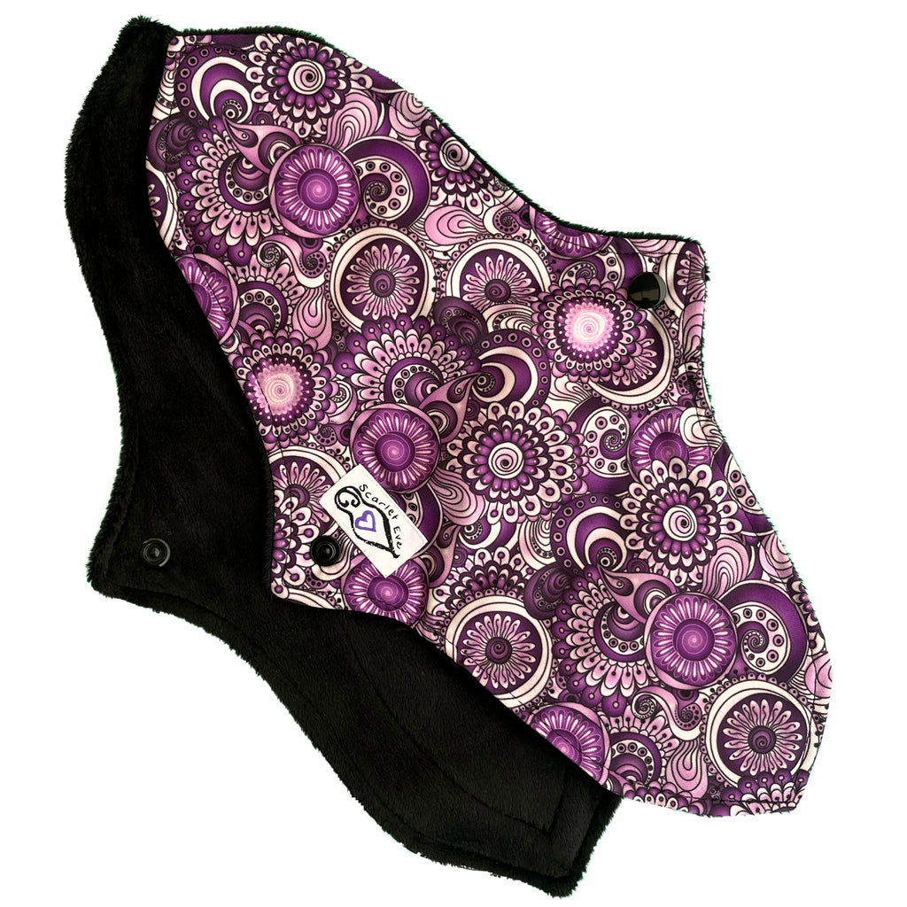 Scarlet Eve Purple Floral Curvy Tall Pad. Top: Plush Black Minky. Bottom: Purple, Black and White Floral PUL. 2 layer bamboo fleece booster sewn in. Contoured shape for snug, form-fitting comfort and coverage without bulk.