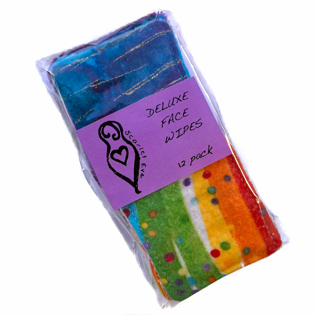 A clear bag with colourful square face wipes inside, against a white background. The front of the bag has a purple label with the Scarlet Eve logo and black text that reads "DELUXE FACE WIPES 12 pack".