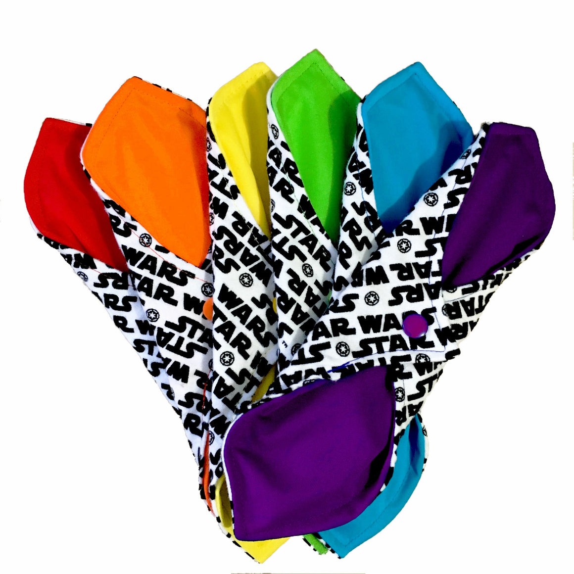 A set of six assorted Curvy Pads with , against a white background. The reusable menstrual Pads are snapped together, showing both sides of the Pads, which have a contoured shape. Each pad has one side of black and white print cotton flannel, and each pad has a solid bright colour on the other side - red, orange, yellow, green, blue and purple.
