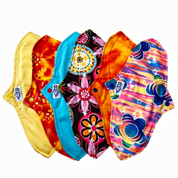 A set of six assorted curvy tall pads with various colorful patterns, against a white background. The Pads have a contoured shape.