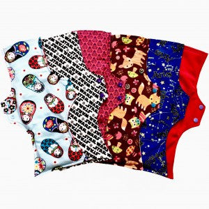 A set of six assorted Uber Long Pads with various colourful patterns, against a white background.  The reusable menstrual Pads are squared at the top and flared at the bottom.