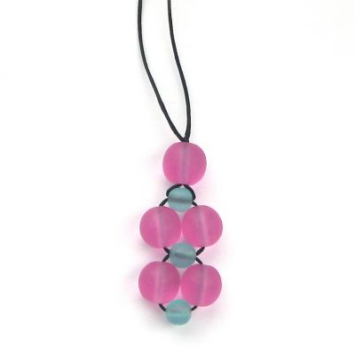 A necklace made from a cluster of pink and aqua beads on black necklace thread, against a white background. 