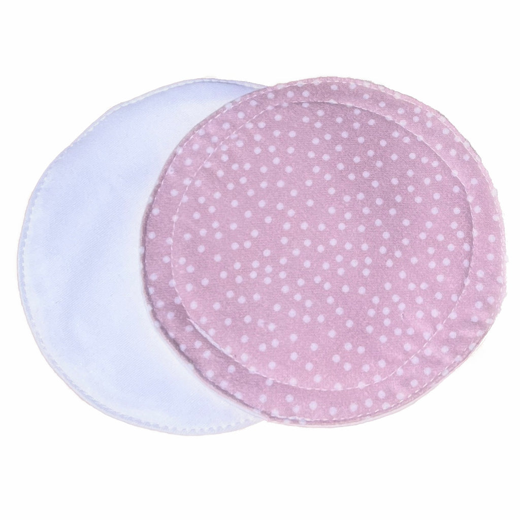 Scarlet Eve Rose Dots Breast Pads. Top: Soft, cotton flannel with small white dots scattered on a rose pink background. Back: solid White PUL. 2 layers bamboo fleece sewn in. Scarlet Eve breast pads have generous coverage and superior absorbency.