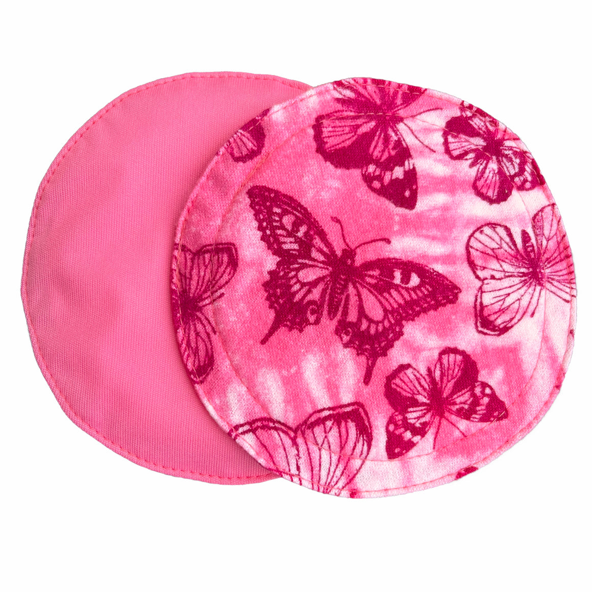 Two reusable nursing pads against a white background. The breast pad on top is made from light pink and white tie dye cotton flannel with maroon butterflies. The breast pad on the bottom is made from raspberry pink PUL fabric.