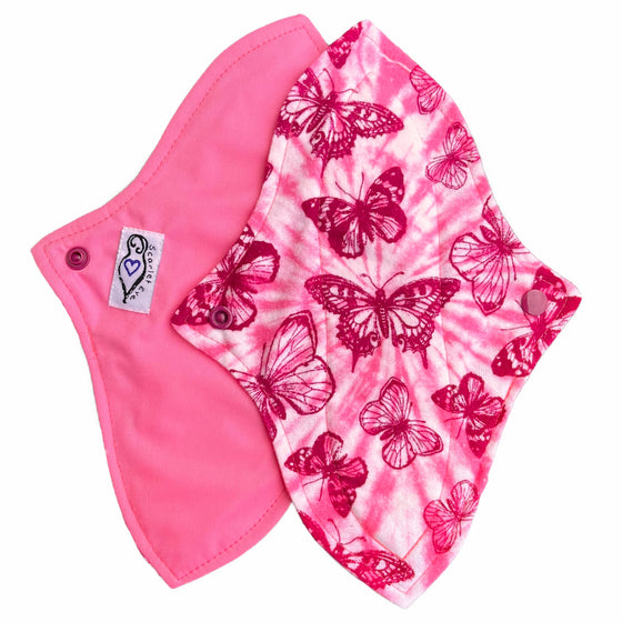 Two reusable menstrual pads with a contoured shape against a white background. The pad on top is made from light pink and white tie dye cotton flannel with maroon butterflies. The pad on the bottom is made from raspberry pink PUL fabric and has a white "Scarlet Eve" label.