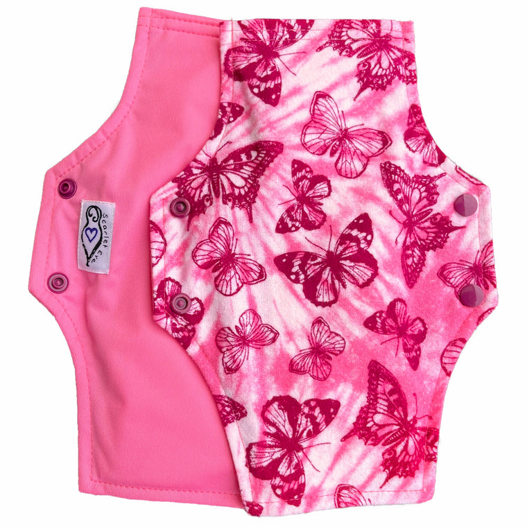 Two reusable menstrual pads with squared top and flared bottom shape against a white background. The pad on top is made from light pink and white tie dye cotton flannel with maroon butterflies. The pad on the bottom is made from raspberry pink PUL fabric and has a white "Scarlet Eve" label.