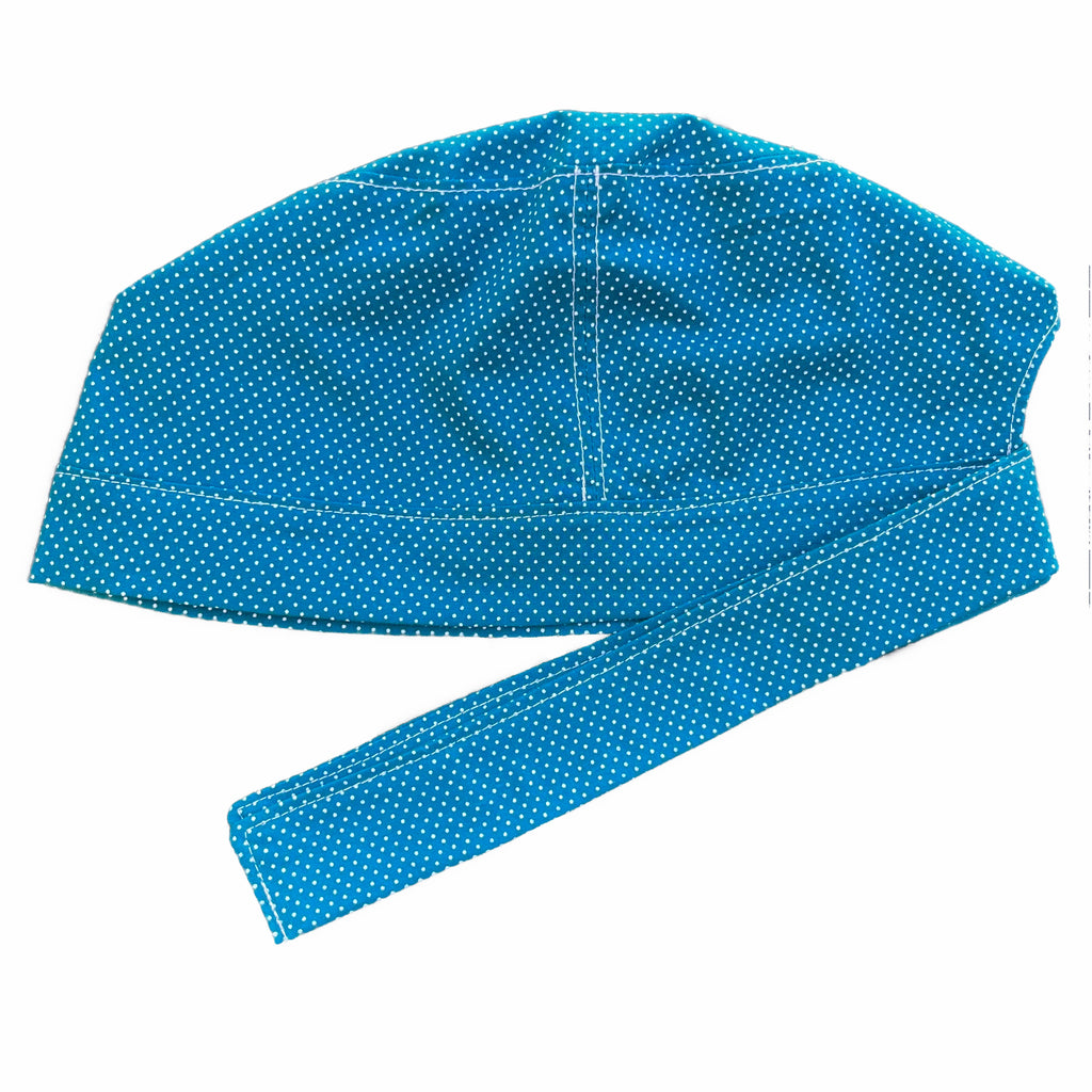 A teal and white scrub cap against a white background. The cap, bottom band and ties are made from teal woven cotton with very small white dots.
