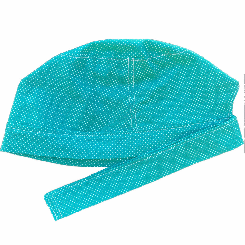 A turquoise and white scrub cap against a white background. The cap, bottom band and ties are made from turquoise woven cotton with very small white dots.